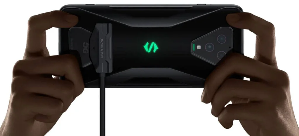 Picture of hands holding the Black Shark 3 Pro taken from the back with the magnetic charging shown