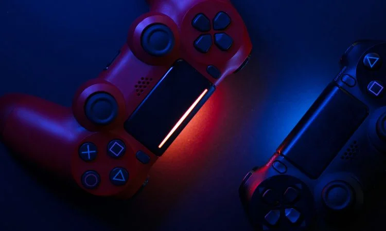 gamepads Picture of two sony playstation gamepads in front of a blue background